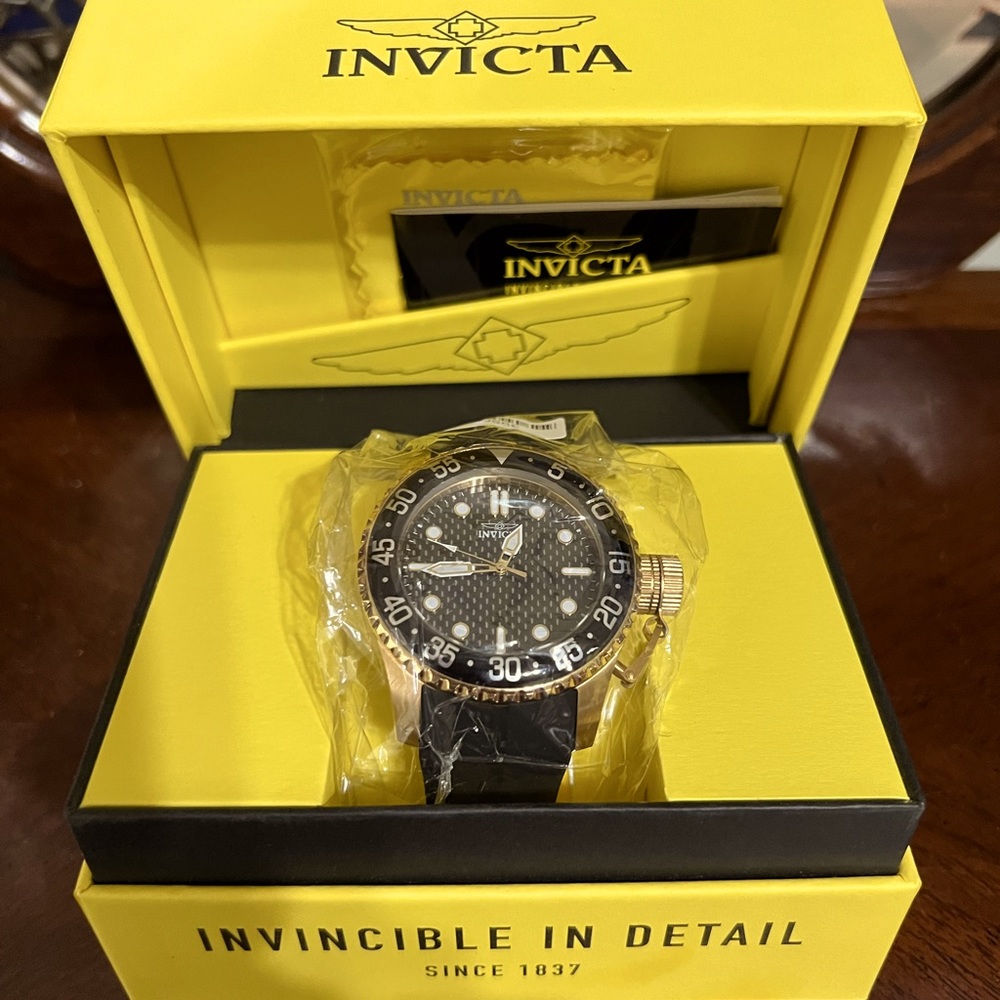 Invicta mens black rubber band watch.
